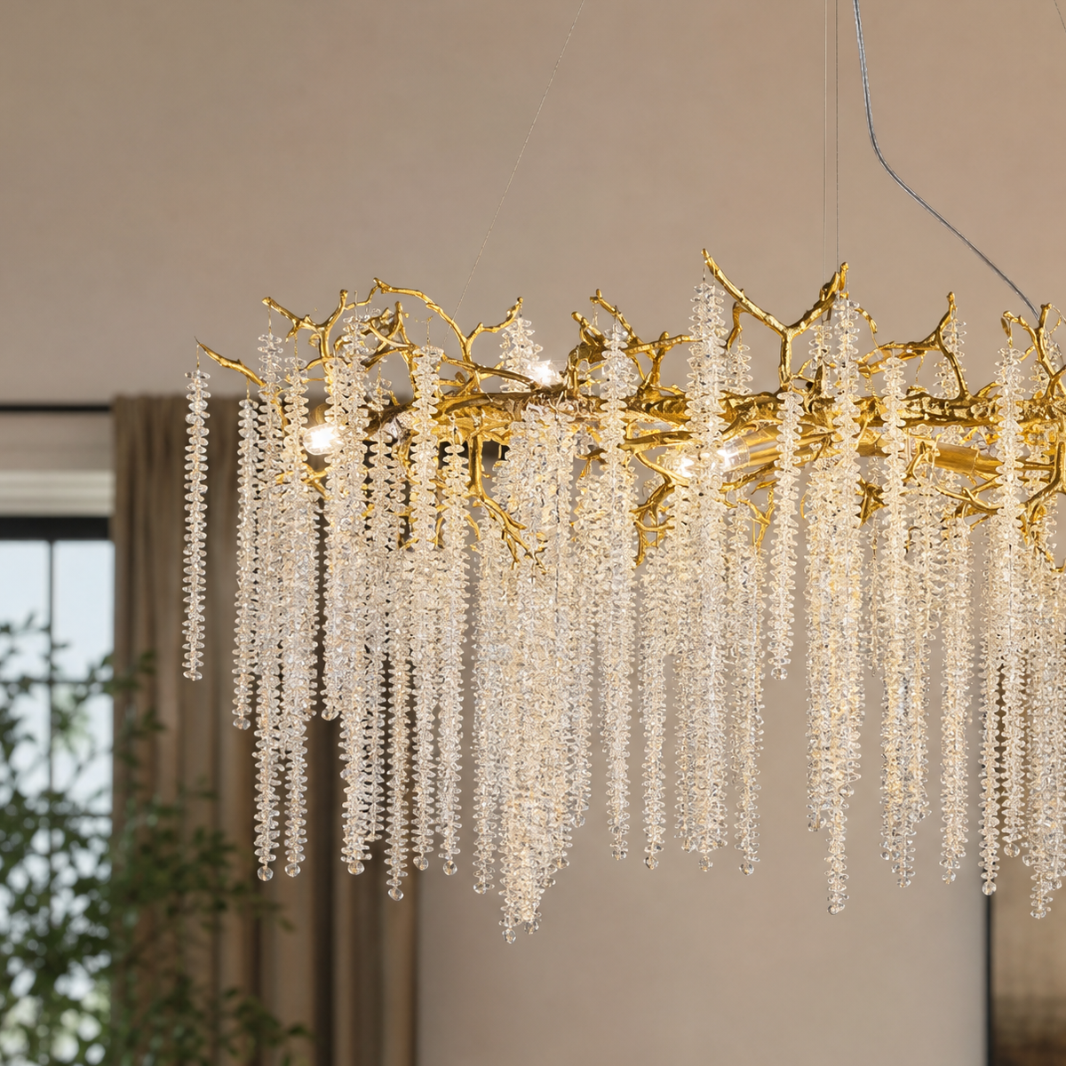 A Trivellolab gold metal branch chandelier with cascading crystal beads suspended in a rainfall arrangement.