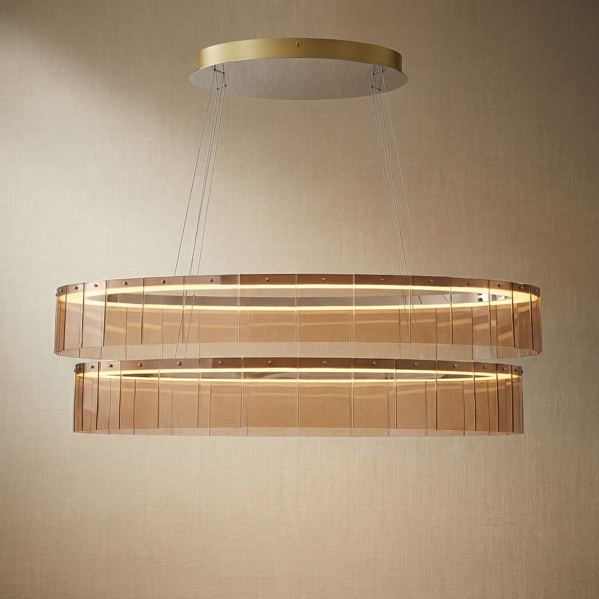 Modern dining room with 59 inch oval glass chandelier over long rectangular table — Trivellolab Astor linear pendant
